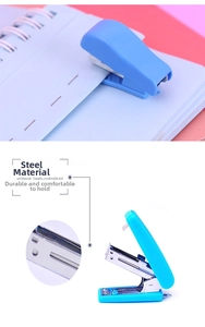 Detail showing blue mini stapler on a notebook with internal steel mechanism