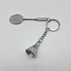 Detailed close-up of a silver badminton racket and shuttlecock keychain in zinc alloy