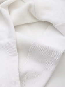 Close-up of white cotton ribbed knit cuff and soft fleece lining for warm sweatshirts