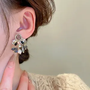 Elegant vintage drop earrings with purple crystal and white pearls on model