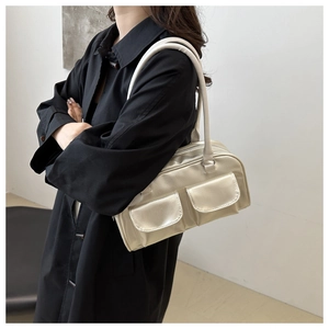 Model wearing a champagne gold retro square shoulder bag with front flap pockets