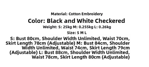 Detail of black and white plaid cotton fabric with delicate embroidery and texture