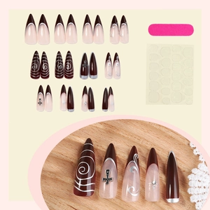 Gothic dark brown press-on nails with metal cross charms and silver swirl designs