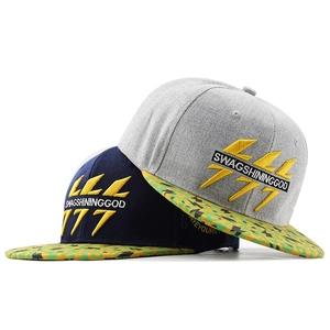 Detail of embroidered yellow lightning and SWAGSHININGGOD text on flat brim baseball caps