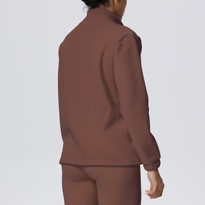 Rear view of brown high-collar sports set showing the soft brushed fabric texture
