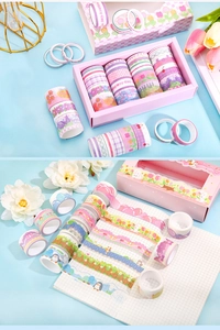 Detail of 20 rolls of animal washi tape set in box used on grid paper for DIY crafts