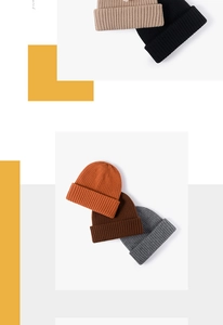 Detail of multi-color ribbed knit beanies in beige, black, and orange with folded cuffs