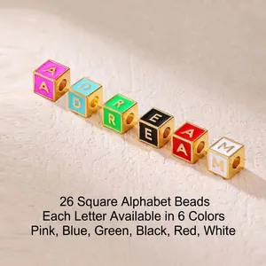 Golden square alphabet beads with DREAM lettering in multi-colored enamel for DIY jewelry