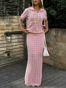 Detail of pink knitted two-piece set featuring wave hollow-out pattern and polo collar