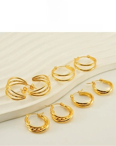 Macro shot of assorted multi-layer gold-plated C-shaped stainless steel hoop earrings