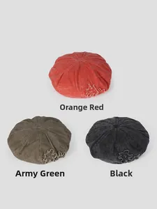 Close-up of vintage washed cotton berets with star patches in orange, green, and black