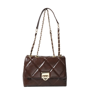Deep brown quilted crossbody bag with gold chain strap and elegant metal clasp lock