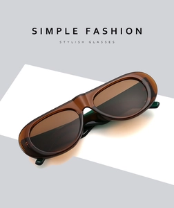 Detailed close-up of retro oval amber brown sunglasses with stylish translucent frames