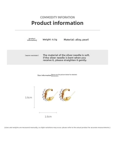 Detail shot of C-shaped gold pearl earrings with silver posts and size measurements