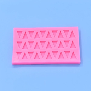 Pink rectangular silicone mold with multiple triangular cavities for DIY baking and crafts