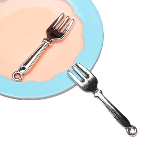 Miniature alloy metal forks on dollhouse plate for DIY jewelry and micro scenes