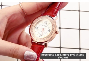 Detail of rose gold ladies quartz watch with rhinestone bezel and red leather strap