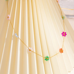 Gold-plated stainless steel chain with colorful beaded flowers on a white background