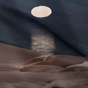 Detail of bohemian tapestry fabric showing fine knit texture and ocean moonrise print