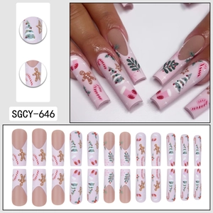 Christmas press-on nails with cute gingerbread man and festive tree designs in pink and white