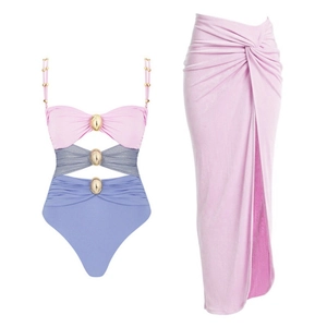 Three-color cutout one-piece swimsuit with gold buckles and matching pink wrap skirt