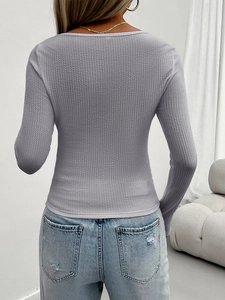 Back view of a gray long sleeve slim fit top with ribbed texture and U-neckline