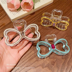 Three-piece set of butterfly and heart rhinestone hair claws in pastel acrylic finishes