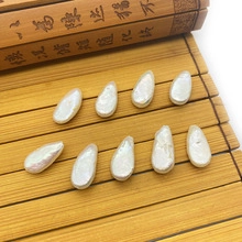 Detailed view of 15-20mm irregular drop-shaped natural freshwater pearls on a bamboo mat