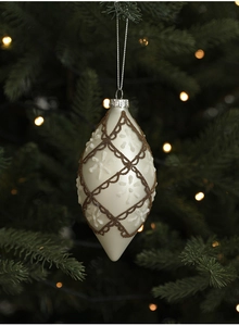 Detail of white drop-shaped Christmas ornament with gold beads and white snowflakes on a tree