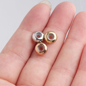 Macro shot of 8mm stainless steel positioning beads with silicone inserts on a finger