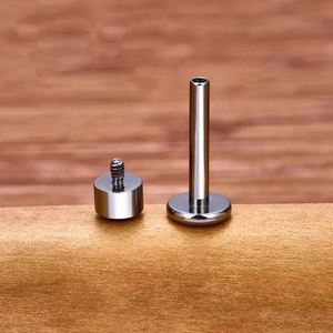 Detailed close-up of silver G23 titanium labret stud showing internal thread and flat base