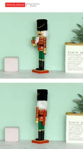 Detail of wooden nutcracker soldier in plaid uniform holding a gold gift box