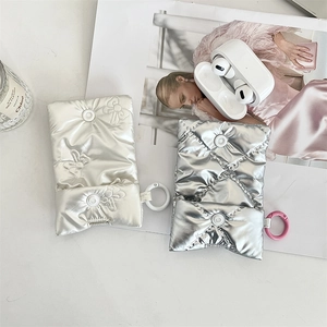 Quilted bow headphone case in metallic silver and pearl white with snap closure