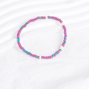Macro view of colorful bohemian bead bracelet set with purple, green, blue and white beads