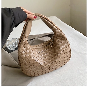 Caramel woven PU leather half-moon handbag with minimalist braided handle and modern style