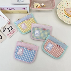 Detailed overhead shot of quilted checkered mini coin purses in pastel macaron colors