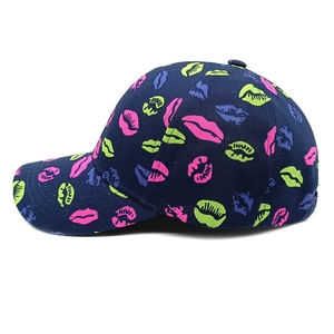 Detail view of navy blue baseball cap with colorful neon lip prints and cotton texture