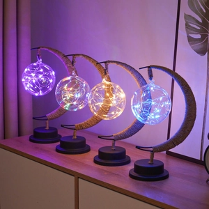 Detail of moon-shaped LED iron decorative lamps with four colorful hanging light spheres