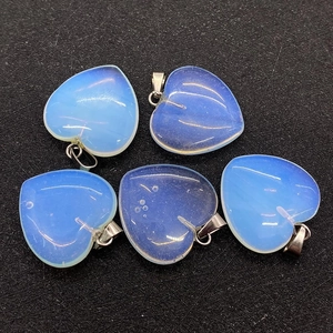 Macro detail of heart-shaped opalite stone pendants with silver metal clasps