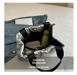 Spacious interior of silver quilted tote bag showing daily essentials and magnetic closure