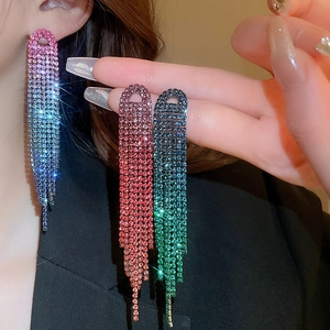 Detail of elegant long tassel rhinestone earrings with gradient crystal colors