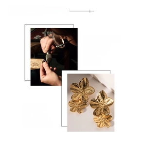 Macro detail of 18K gold plated floral earrings with handcrafted polished texture