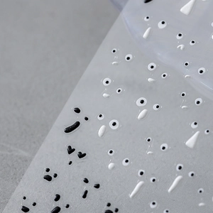 5D embossed nail art stickers featuring black and white cartoon expressions on transparent base