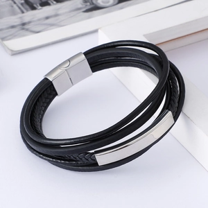 Detail of men's multi-layer black leather bracelet with silver magnetic metal clasp