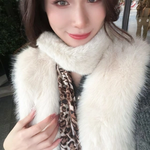 Detail of soft cream faux fur scarf with trendy leopard print lining for winter warmth