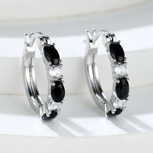 Elegant silver hoop earrings with alternating black oval stones and white round zircons