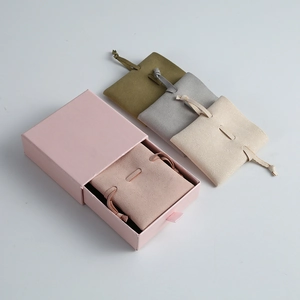 Soft microfiber jewelry pouches in multiple colors presented with a pink gift drawer box.