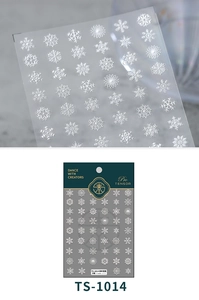 Macro view of 5D embossed white winter snowflake nail art stickers with textured finish