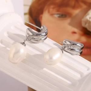Detail of elegant baroque pearl earrings with 18K gold-plated stainless steel base
