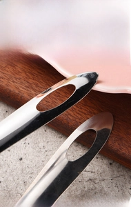 Detail of stainless steel handle with hanging hole for easy kitchen space saving